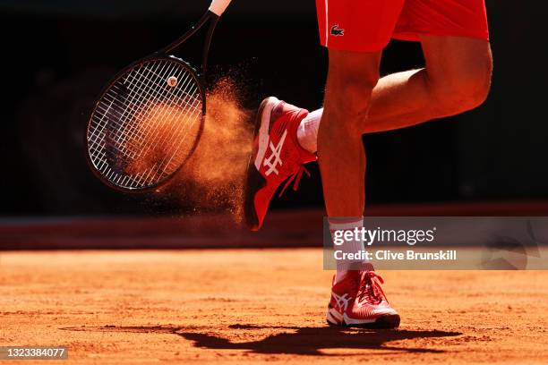 Detailed view as Novak Djokovic of Serbia taps clay out of his shoes in his Men's Singles Final match against Stefanos Tsitsipas of Greece during Day...