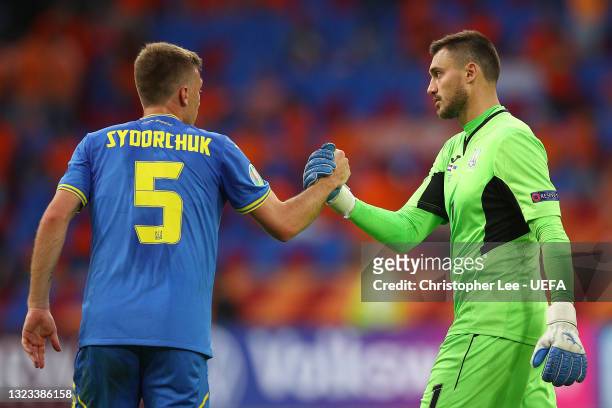 Georgiy Bushchan of Ukraine shakes hands with team mate Serhiy Sydorchuk during the UEFA Euro 2020 Championship Group C match between Netherlands and...