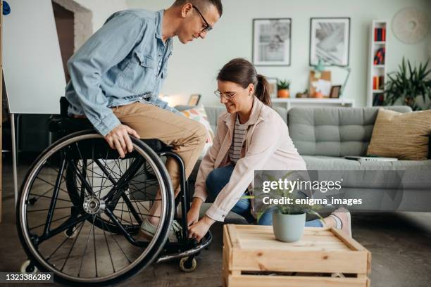 love has conquered everything - cadeira de rodas imagens e fotografias de stock