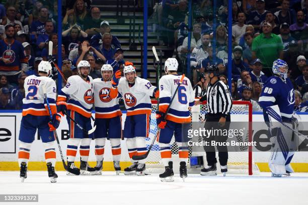 Mathew Barzal of the New York Islanders is congratulated by his teammates after scoring a goal past Andrei Vasilevskiy of the Tampa Bay Lightning...