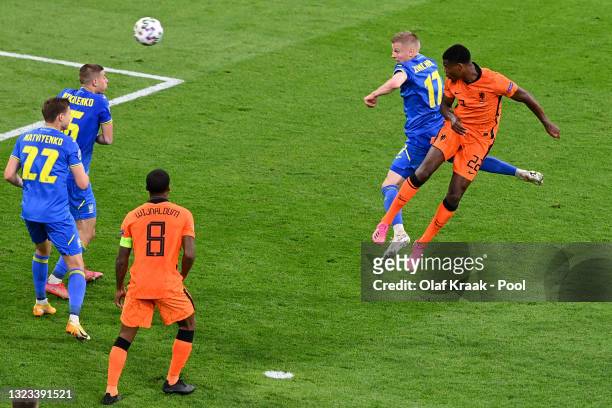 Denzel Dumfries of Netherlands scores their side's third goal whilst under pressure from Oleksandr Zinchenko of Ukraine during the UEFA Euro 2020...