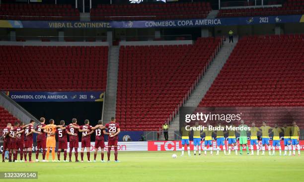 Players of Brazil and Venezuela observe a minute of silence in honor to victims of COVID-19 before a Group B match between Brazil and Venezuela as...