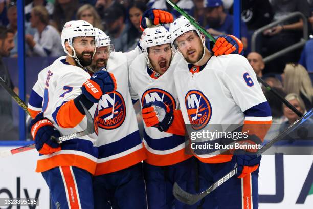 Ryan Pulock of the New York Islanders is congratulated by Jordan Eberle, Andy Greene and Mathew Barzal after scoring a goal against the Tampa Bay...