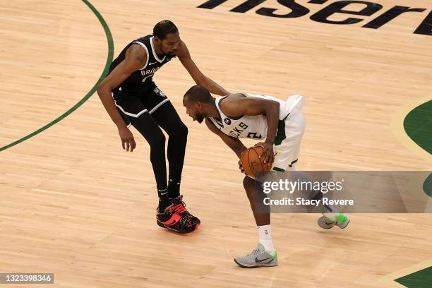 Khris Middleton of the Milwaukee Bucks is defended by Kevin Durant of the Brooklyn Nets during the second half of Game Four of the Eastern Conference...