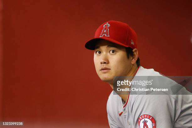 Shohei Ohtani of the Los Angeles Angels watches from the dugout during the fifth inning of the MLB game against the Arizona Diamondbacks at Chase...