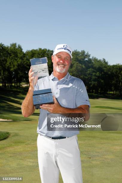 Jerry Kelly of the United States holds the winners trophy on the 18th green after winning the American Family Insurance Championship at University...