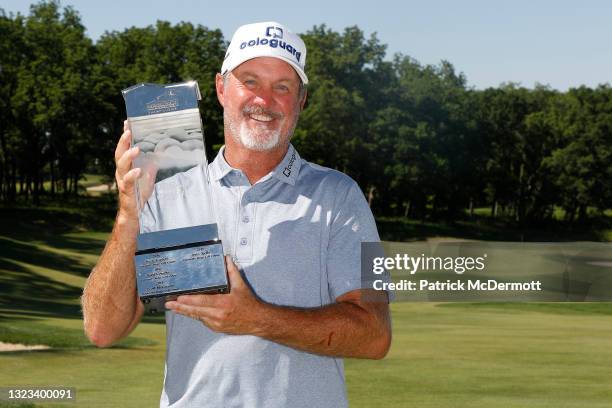 Jerry Kelly of the United States holds the winners trophy on the 18th green after winning the American Family Insurance Championship at University...