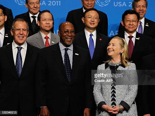 Secretary of State Hillary Rodham Clinton looks at US Trade Representative Ron Kirk as they pose with Foreign Minister of Russia Sergey Lavrov and...