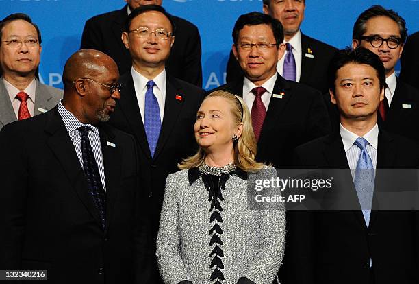 Secretary of State Hillary Rodham Clinton looks at US Trade Representative Ron Kirk as they pose with Foreign Minister of Japan Koichiro Gemba and...