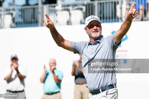 Jerry Kelly of the United States celebrates as he is introduced during the award ceremony on the 18th green after winning the American Family...