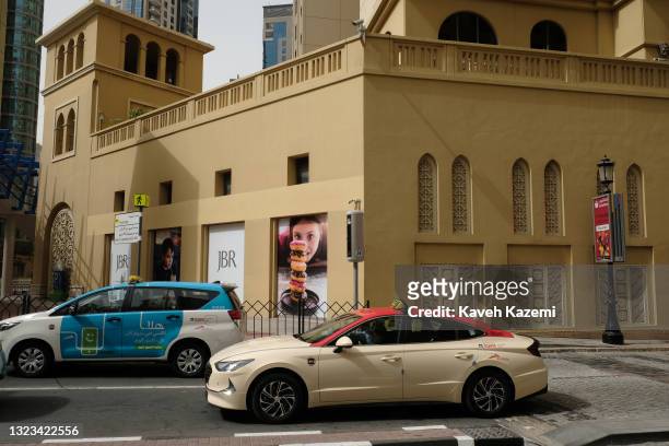 Modern Dubai taxis seen behind a traffic light in Dubai Marina neighbourhood on March 14, 2021 in Dubai, United Arab Emirates.