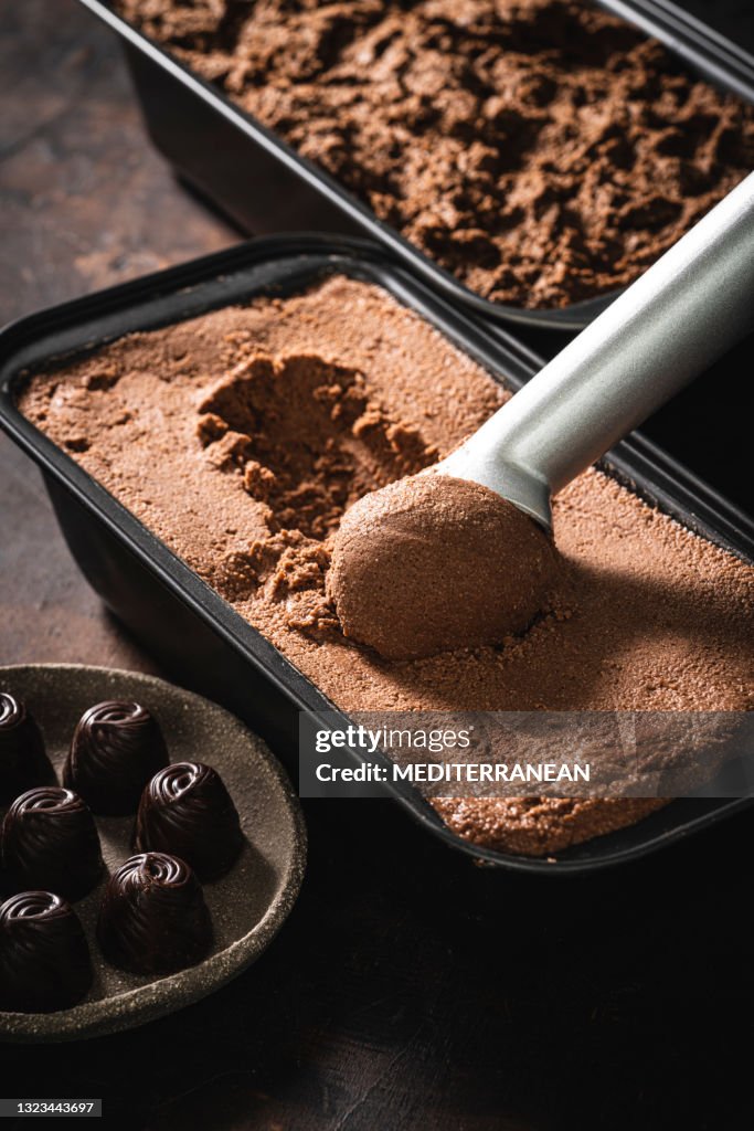 Chocolate ice cream scoop ball serving and chocolates macro close-up