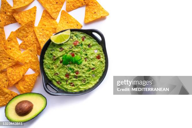 guacamole avocado dip with nacho chips with tomato and chili isolated on white - avocado isolated stock pictures, royalty-free photos & images