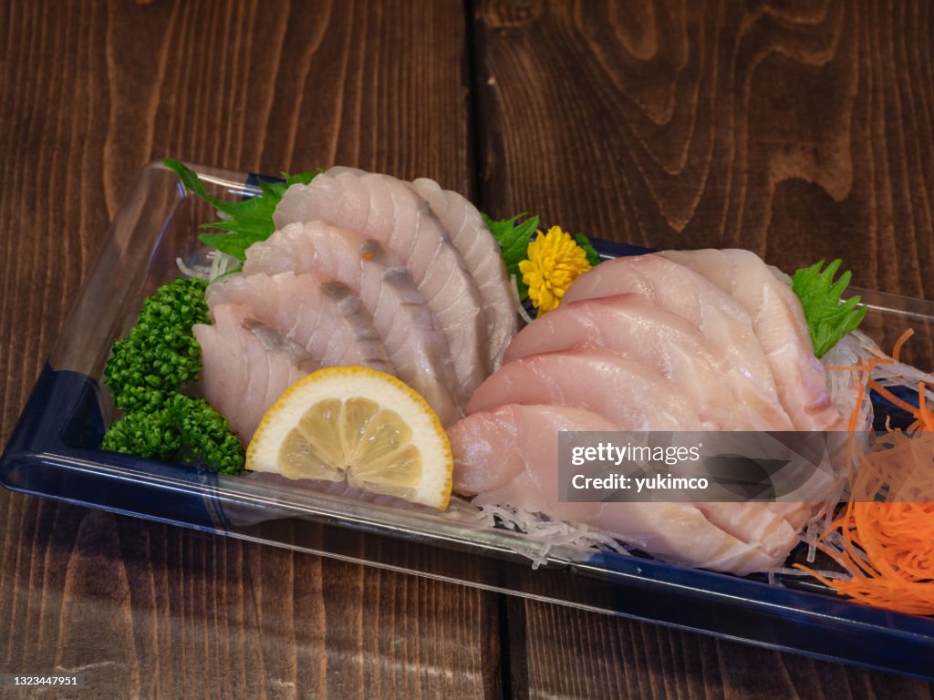 Spanish mackerel sashimi in a plastic container.