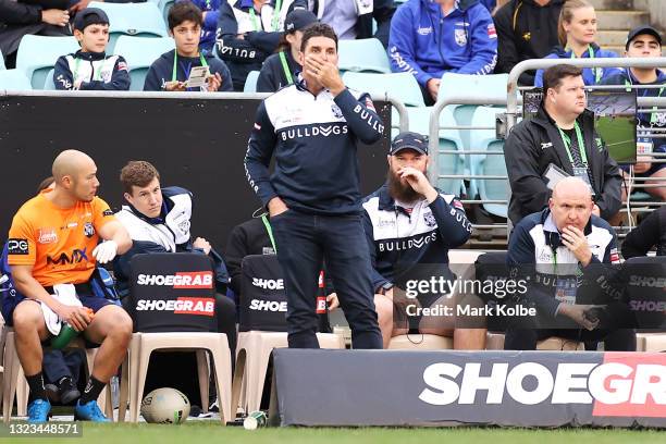 Bulldogs coach Trent Barrett looks dejected as Josh Jackson of the Bulldogs leaves the field after being sent off for 10 minutes during the round 14...