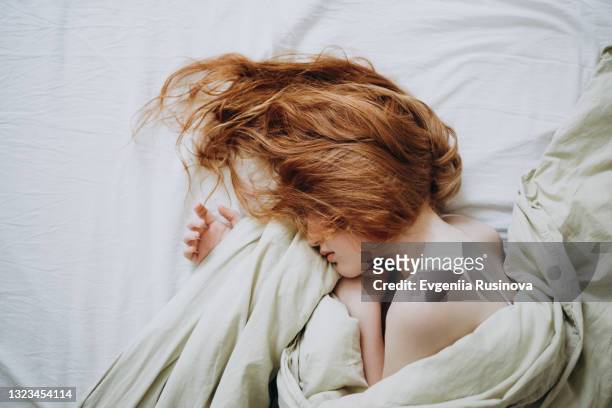sleeping red-haired girl - beds dreaming children stock pictures, royalty-free photos & images