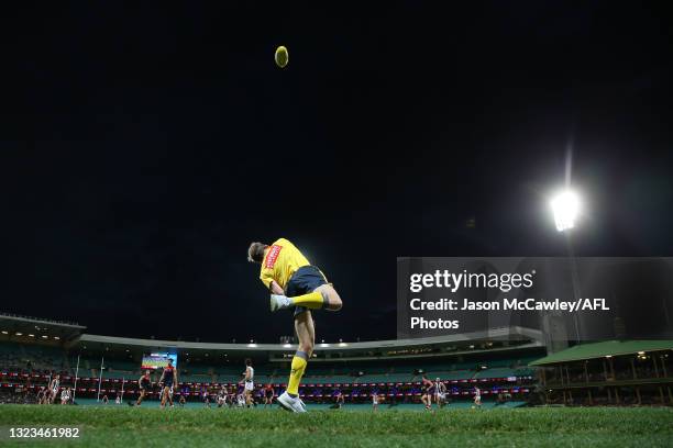 Boundary umpire throws the ball in during the round 13 AFL match between the Melbourne Demons and the Collingwood Magpies at Sydney Cricket Ground on...