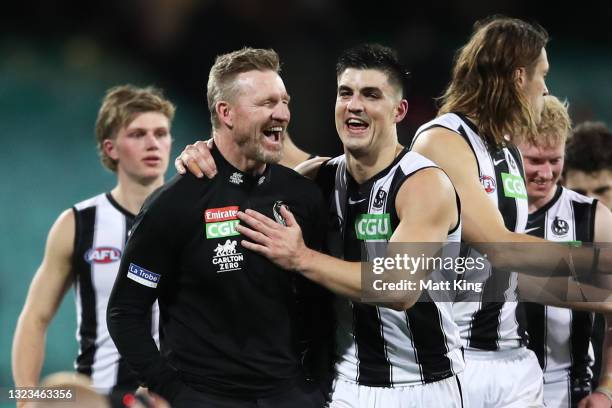 Magpies head coach Nathan Buckley celebrates victory with Brayden Maynard of the Magpies and team mates after the round 13 AFL match between the...