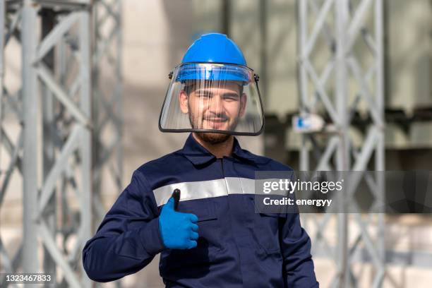 young technician at the substation - helmet visor stock pictures, royalty-free photos & images