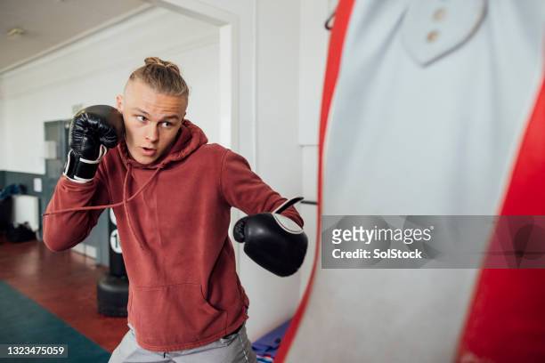 boxing training in the gym - punching bag stock pictures, royalty-free photos & images