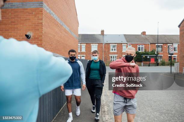 friend's meeting up for a run - elbow bump stock pictures, royalty-free photos & images