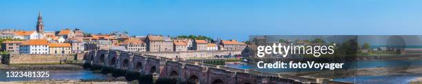 bridge over ocean inlet to walled town panorama berwick-upon-tweed northumberland - east lothian stock pictures, royalty-free photos & images