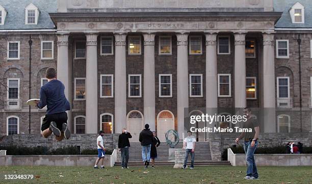 Penn State students play frisbee in front of Old Main on campus in the wake of the Jerry Sandusky scandal on November 11, 2011 in State College,...