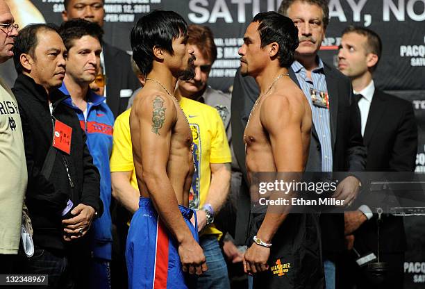 Boxers Manny Pacquiao and Juan Manuel Marquez pose during the official weigh-in for their bout at the MGM Grand Garden Arena November 11, 2011 in Las...