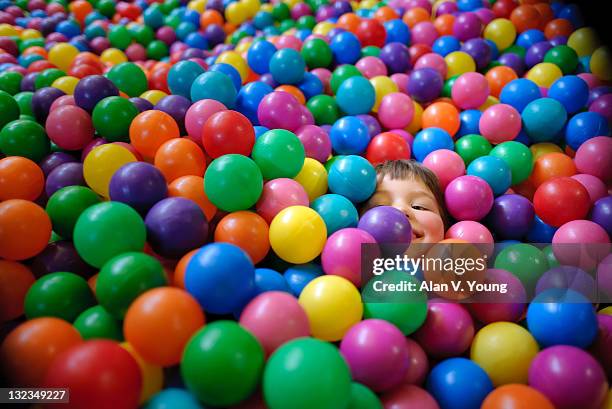 little boy playing in ball pit - ball pit stock pictures, royalty-free photos & images