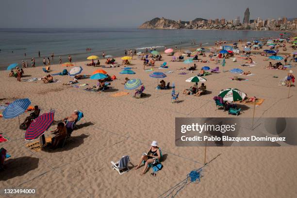 People enjoy the beach observing social distancing on June 14, 2021 in Benidorm, Spain. Spain's immunisation drive, which has fully vaccinated more...