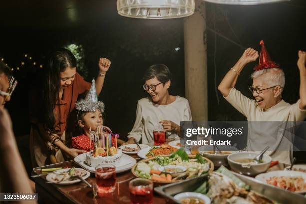 thai family enjoys in little girl's birthday party together - stock photo - family game night stock pictures, royalty-free photos & images