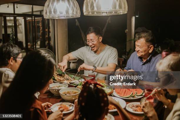 local thai-chinese family having party dinner-stock photo - family dinner stock pictures, royalty-free photos & images