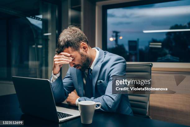businessman working late in the office. - head in hands computer stock pictures, royalty-free photos & images