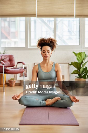 Young Woman Practicing Breathing Exercise At Home Young Woman Practicing Breathing Exercise At Home