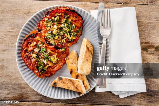 baked beefsteak tomato with pitta bread - beefsteak tomato stock pictures, royalty-free photos & images