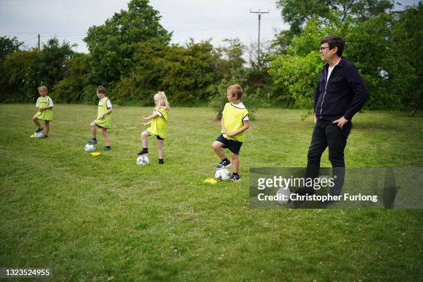 Manchester Metro Mayor Andy Burnham takes part in football training session at Hartshead Primary School during campaigning with Kim Leadbeater,...