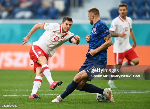 Robert Lewandowski of Poland shoots whilst under pressure from Milan Skriniar of Slovakia during the UEFA Euro 2020 Championship Group E match...