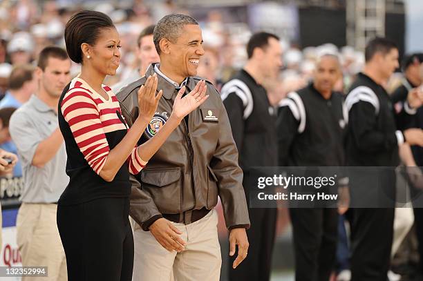 President Barack Obama and first lady Michelle Obama speak to the crowd before the start of the NCAA men's college basketball Carrier Classic between...