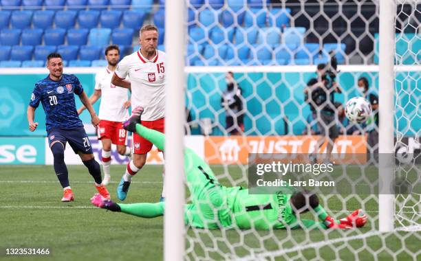 Wojciech Szczesny of Poland scores an own goal for Slovakia's first goal as Robert Mak of Slovakia looks on after shooting during the UEFA Euro 2020...