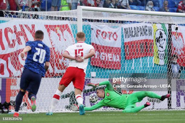 Wojciech Szczesny of Poland scores an own goal for Slovakia's first goal as Robert Mak of Slovakia looks on after shooting during the UEFA Euro 2020...