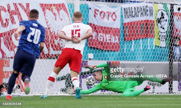 Wojciech Szczesny of Poland scores an own goal for Slovakia's first goal as Robert Mak of Slovakia looks on after shooting during the UEFA Euro 2020...