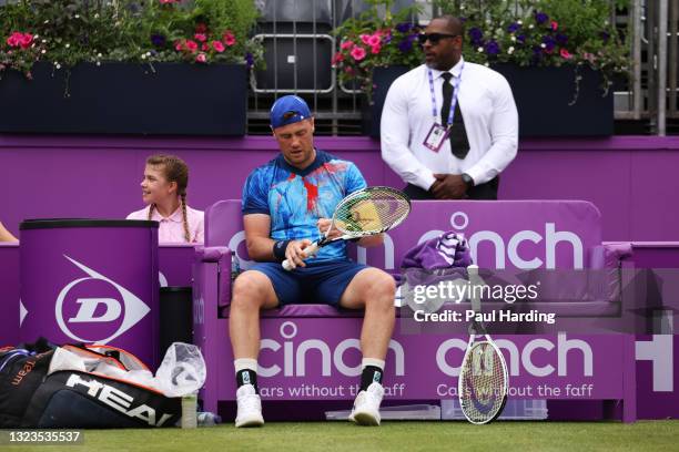 Illya Marchenko of Ukraine reacts as he sits down during a change of ends in his First Round match against Feliciano Lopez of Spain during Day 1 of...