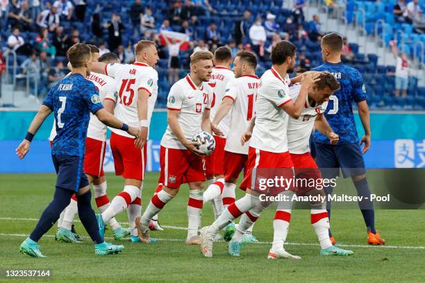 Karol Linetty of Poland celebrates with team mates after scoring their side's first goal during the UEFA Euro 2020 Championship Group E match between...