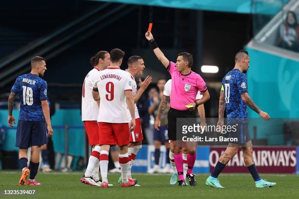 Grzegorz Krychowiak of Poland is shown a red card by Match Referee, Ovidiu Hategan during the UEFA Euro 2020 Championship Group E match between...