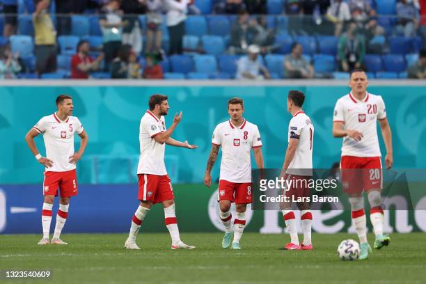 Karol Linetty of Poland and team mates look dejected after conceding a goal scored by Milan Skriniar of Slovakia during the UEFA Euro 2020...