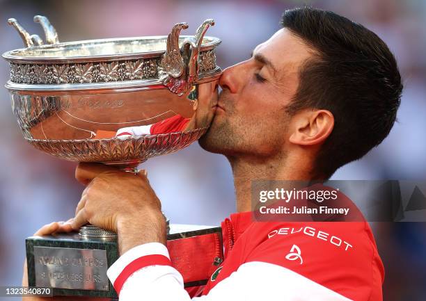 Novak Djokovic of Serbia celebrates as he kisses the trophy after winning his Men's Singles Final match against Stefanos Tsitsipas of Greece during...