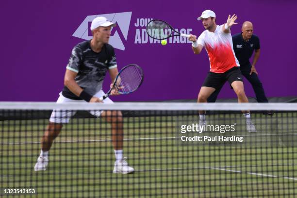 Luke Bambridge of Great Britain, playing partner of Dominic Inglot of Great Britain plays a forehand in their First Round Doubles match against James...
