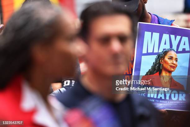 Supporters hold signs as New York City Mayoral candidate Maya Wiley speaks during a small press conference after voting early at Erasmus Hall High...