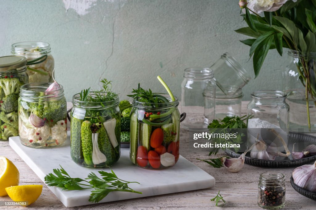 Canning process. Cucumer, tomatoes, garlic, seasoning. Fermented foods