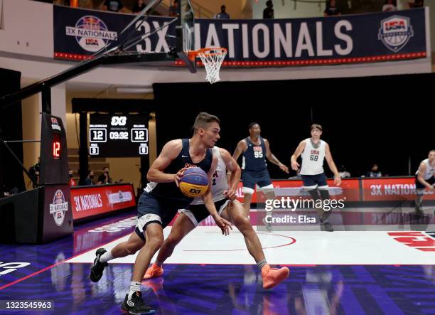 Dylan Travis of 3BALL Omaha drives around Sam Gabbard of 3BALL Olympic Club during the Red Bull USA Basketball 3X Nationals at Naismith Memorial...